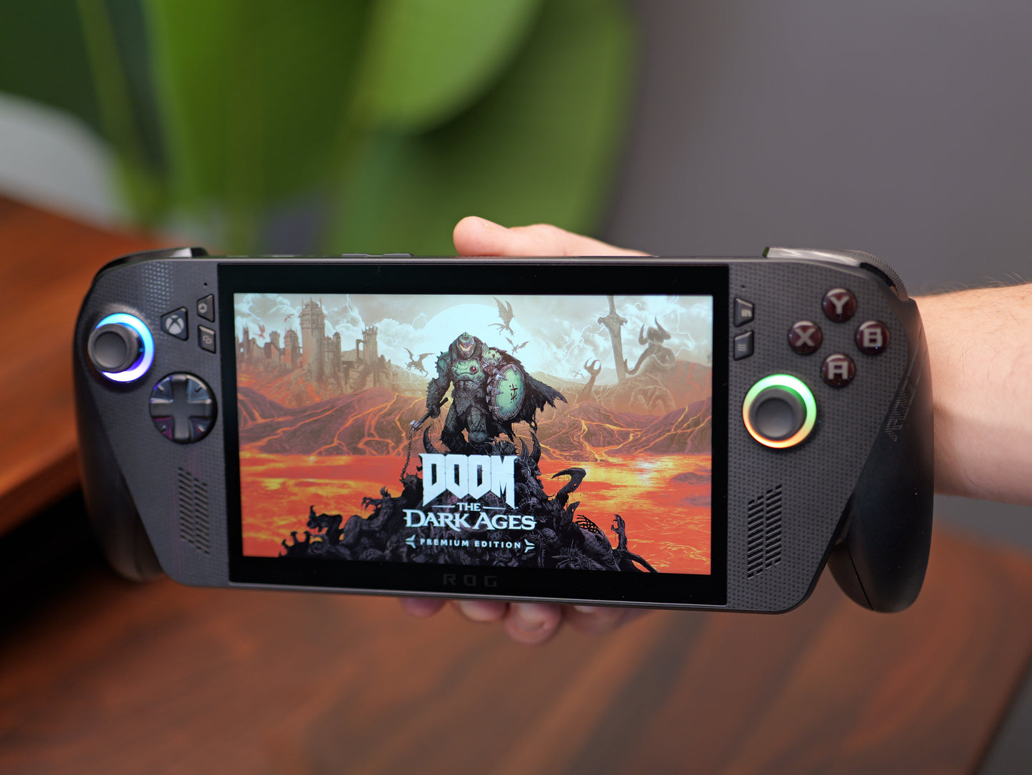 ROG Xbox Ally X displaying DOOM: The Dark Ages while held in both hands