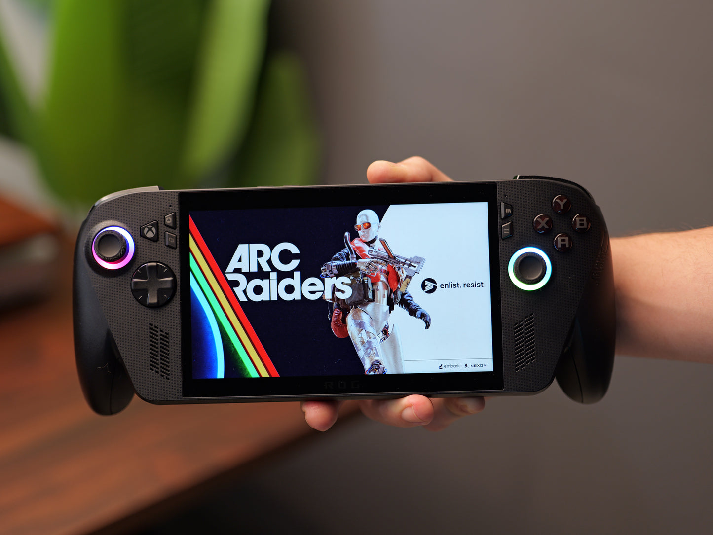 ROG Xbox Ally X displaying ARC Raiders while held in both hands
